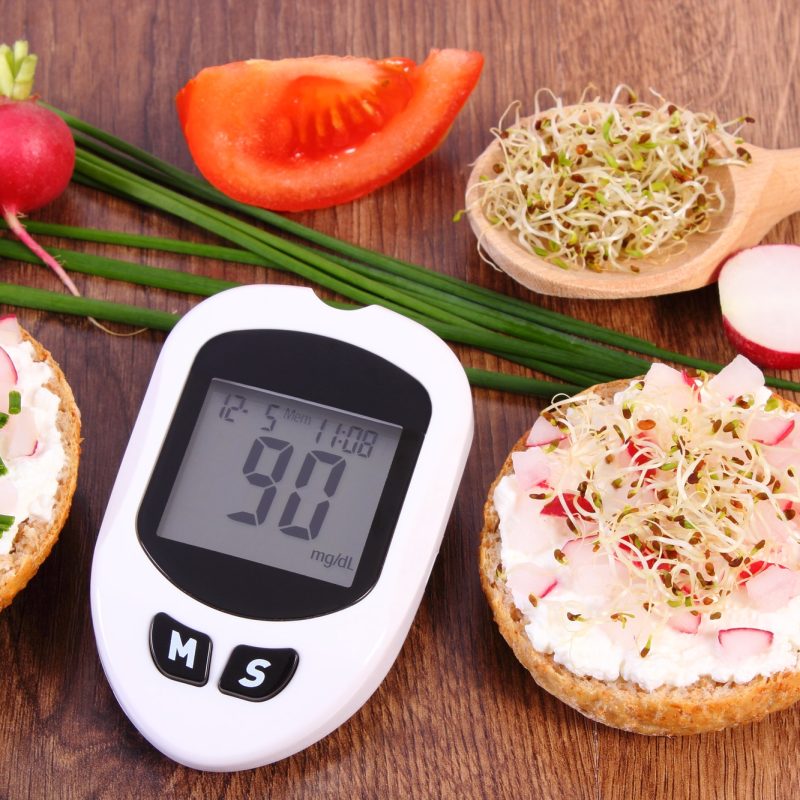 Glucometer for checking sugar level and freshly sandwich with vegetables, diabetes concept