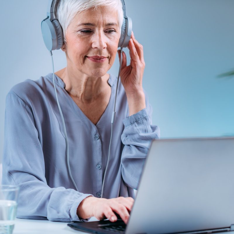 Senior Woman Doing Audiogram Hearing Test at Home, using Laptop